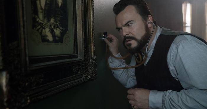 Jack Black uses a stethoscope on a painting