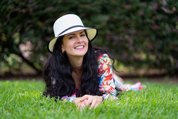 Woman in Hat Lying on Grass