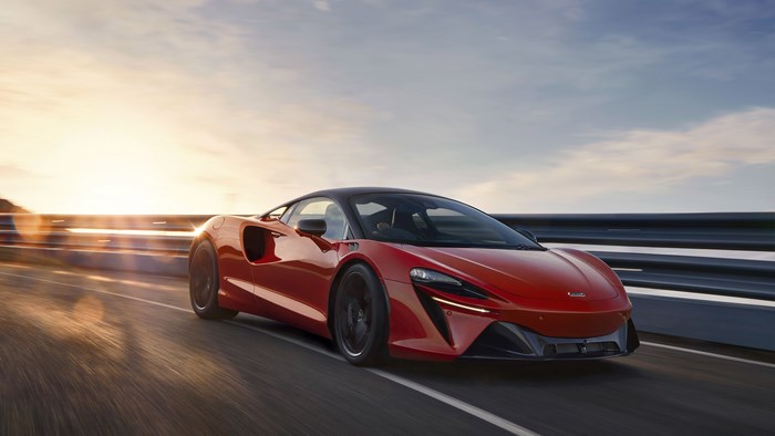 Red McLaren Artura Supercar on a Road