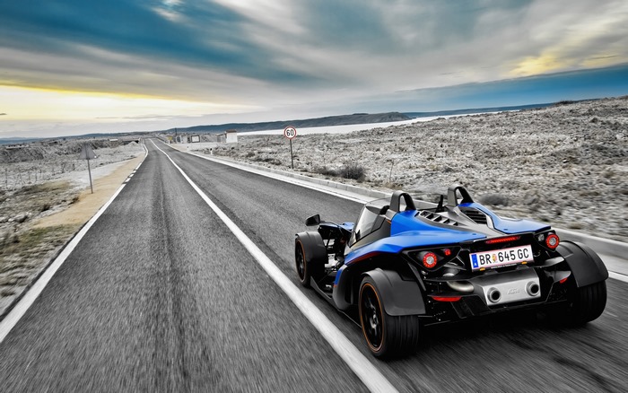 Blue KTM X-Bow GT driving on a road