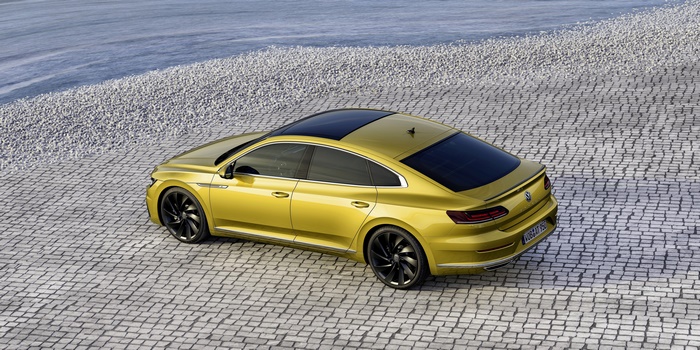 Yellow Volkswagen Arteon R-Line parked on cobblestone