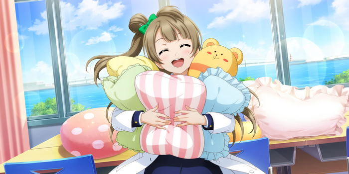 Kotori Minami holding many pillows