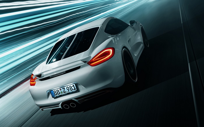 White Porsche Cayman driving on a road with light trails