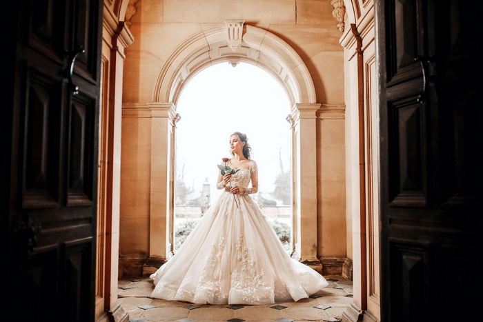 Bride in a white dress holding a rose