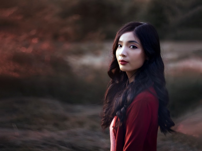 Asian woman with black hair and red shirt