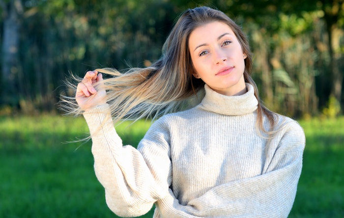 Woman with blonde hair in a turtleneck sweater