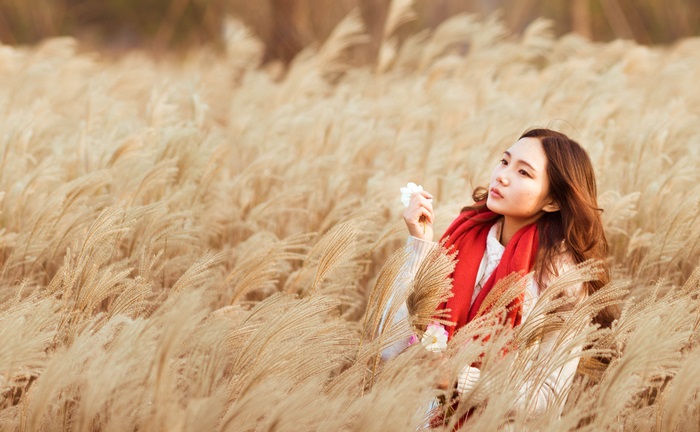 Asian woman in a field of wheat