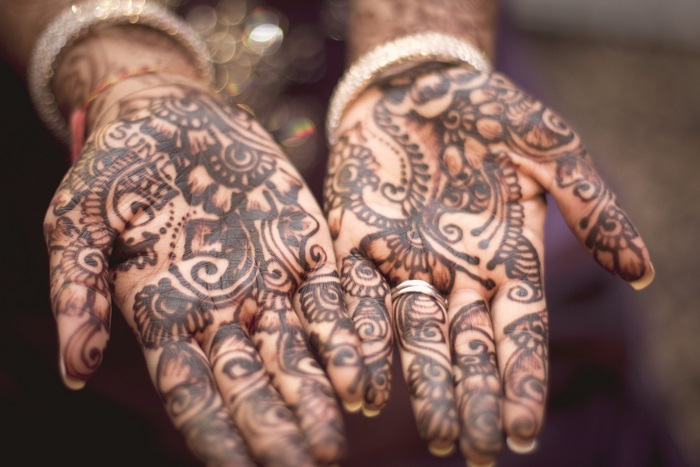 Hands with Mehndi and a Ring