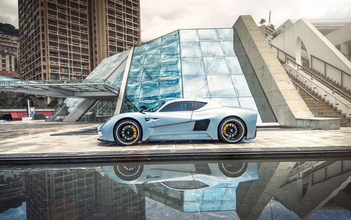 Mazzanti Evantra silver sport car in front of modern architecture