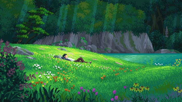 Couple relaxing in a field by the water