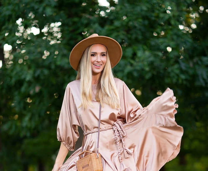 Woman in a hat and dress with a purse