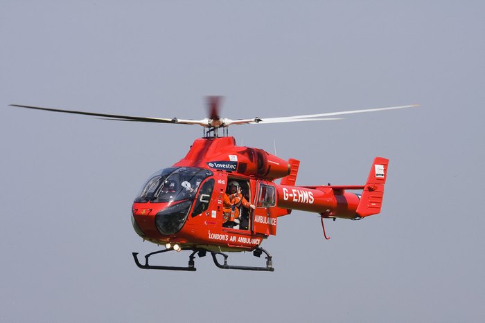 Red London Air Ambulance Helicopter G-EHMS in flight
