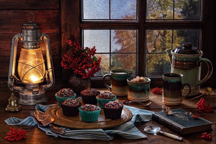 Still life with cupcakes, lantern, and rowan berries
