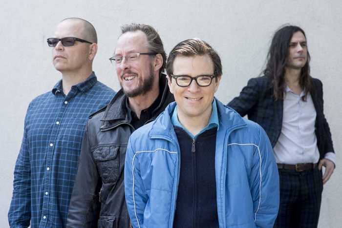 Weezer band members posing for a photo