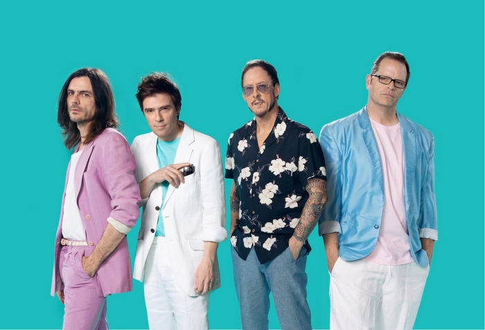 Weezer band members posing against a teal background