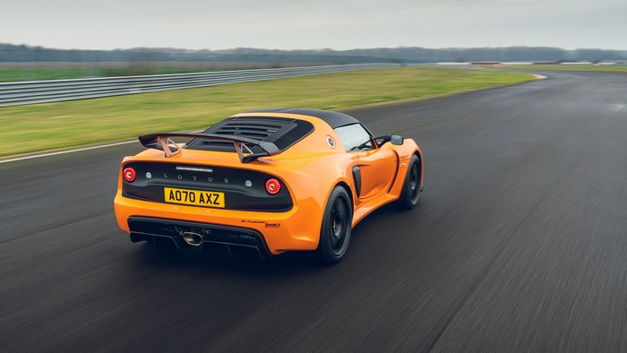 Orange Lotus Exige Sport 390 driving on a race track