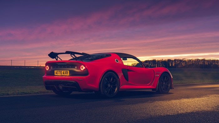 Red Lotus Exige Sport 420 driving at sunset