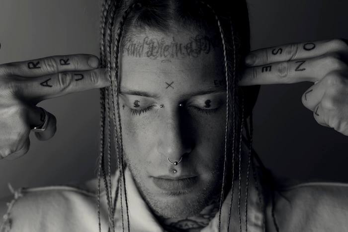 Tom MacDonald with tattoos and braids