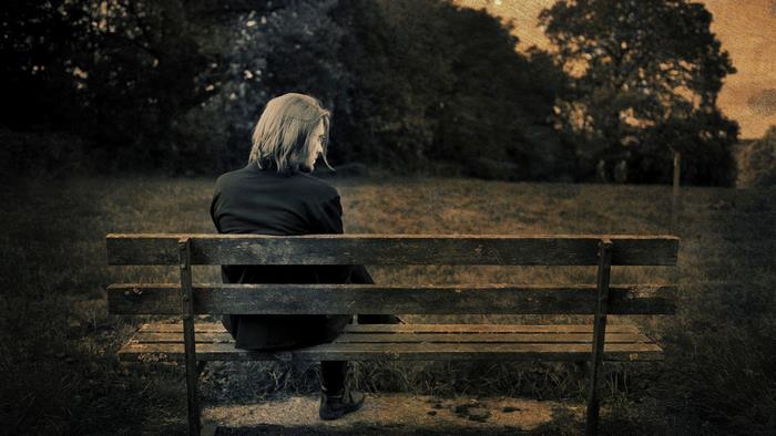Steven Wilson sitting on a park bench