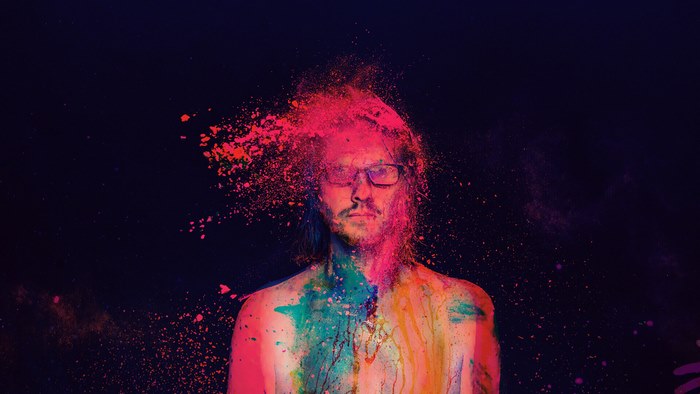 Steven Wilson covered in colorful powder
