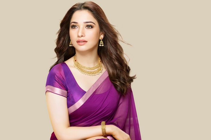 Tamannaah Bhatia wearing a purple saree and gold jewelry