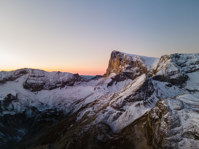 Snow-covered mountains at sunrise 4K