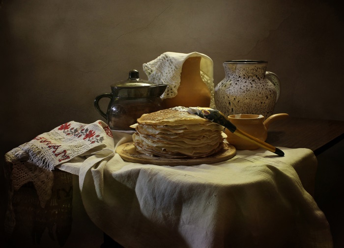 Still life with a stack of crepes and pottery