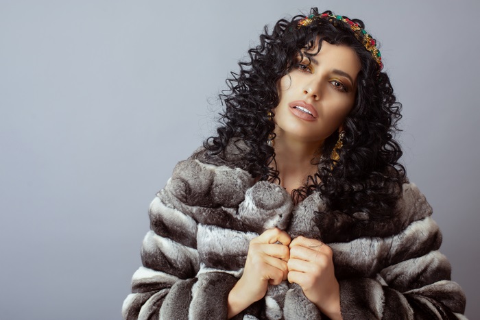 Woman with Black Curly Hair and Fur Coat