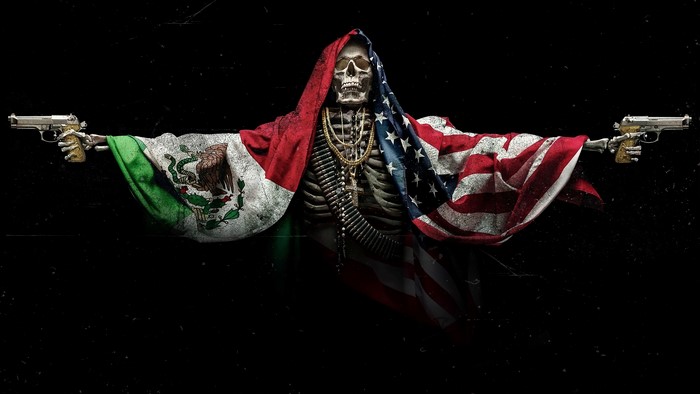 Skeleton draped in Mexican and US flags holding guns