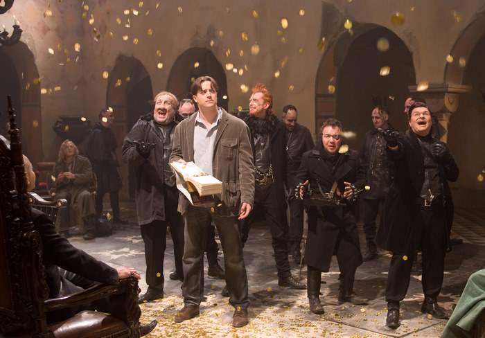 Brendan Fraser and actors from Inkheart in a room with falling gold coins