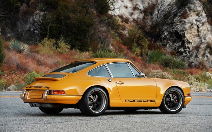 Yellow Porsche 911 on a Mountain Road