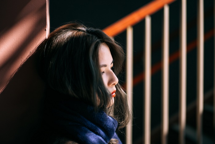 Asian woman with red lipstick and blue scarf