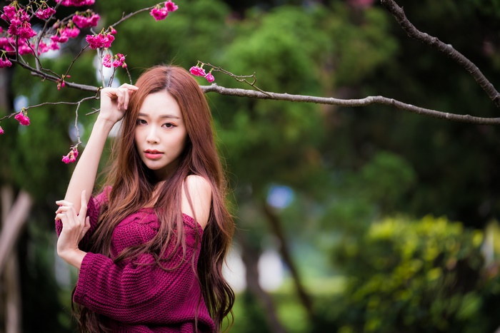Asian woman with long brown hair in a burgundy sweater