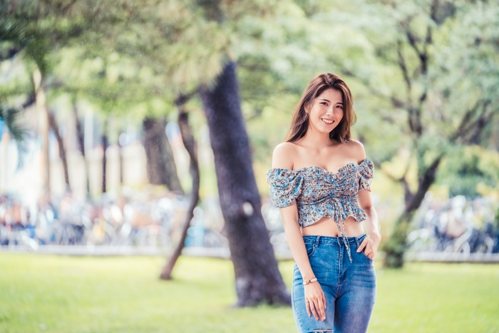 Asian woman smiling in a park