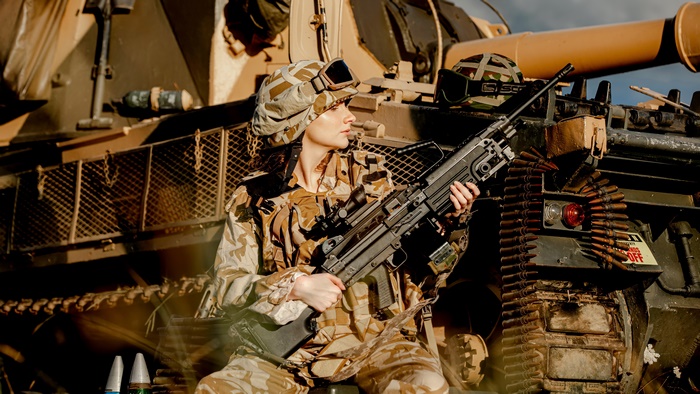 Soldier with a Machine Gun near a Tank