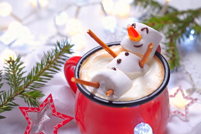 Marshmallow snowman in hot chocolate with Christmas lights