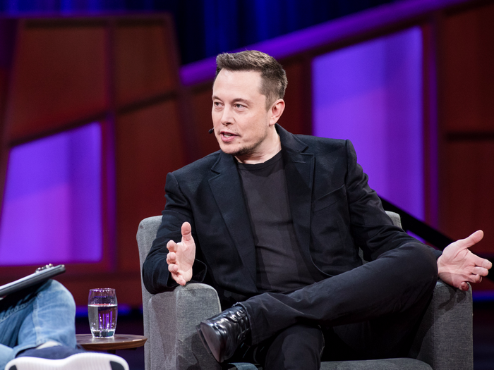 Elon Musk Giving a Talk in a Modern Setting