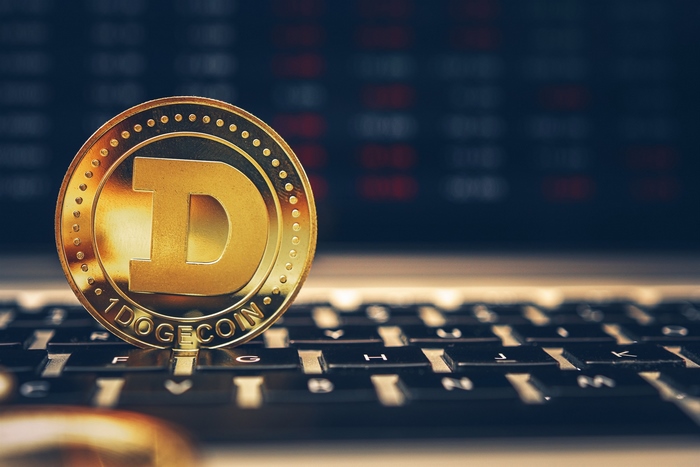 Dogecoin cryptocurrency coin on a laptop keyboard