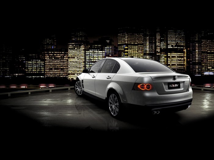 Silver Holden HSV-E Series car at night with city skyline