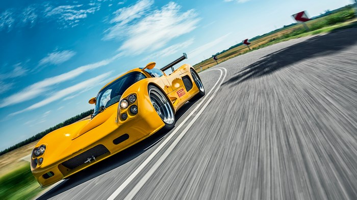 Yellow Ultima GTR 2005 sports car on a winding road