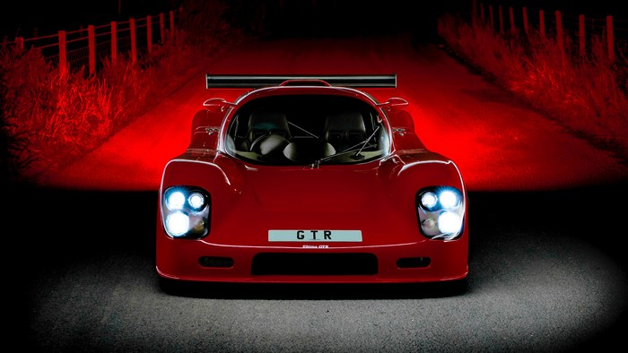 Red Ultima GTR sports car at night