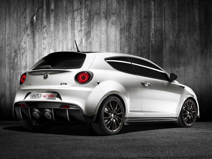 White Alfa Romeo MiTo GTA hatchback parked against a concrete wall