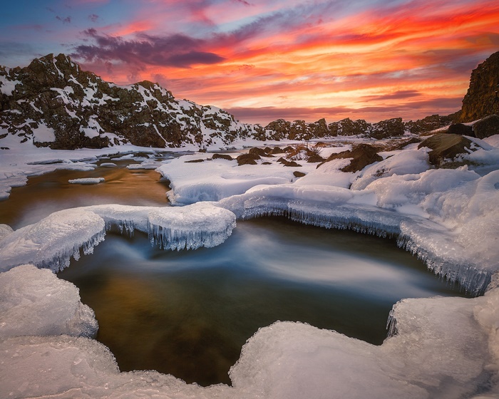Winter Sunset Over Frozen River in Iceland