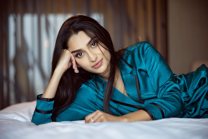 Woman with brown eyes wearing a teal robe