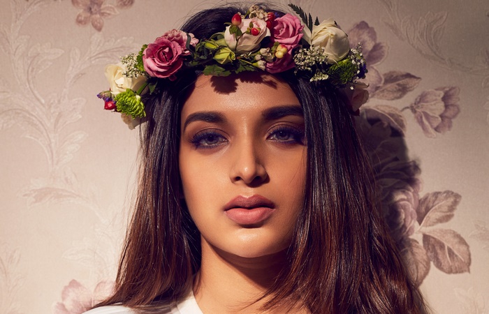 Nidhhi Agerwal wearing a floral wreath