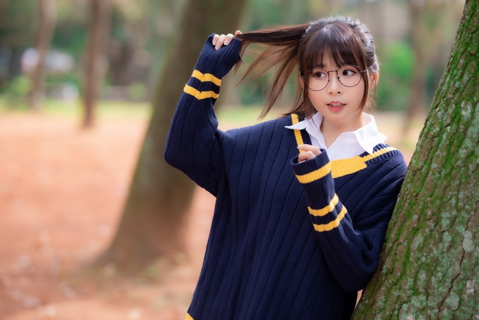 Asian woman with glasses in a sweater