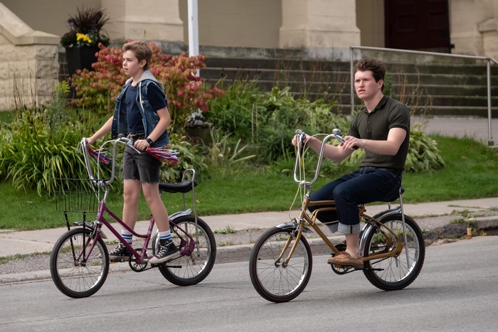 Two boys riding bicycles
