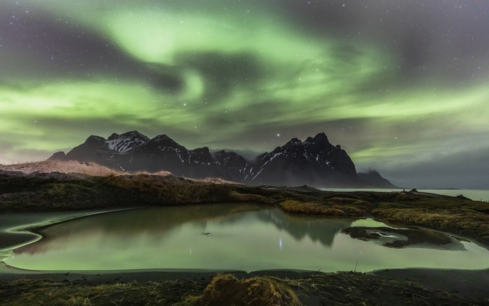 Aurora Borealis over Mountains and Water