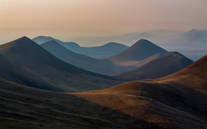 Rolling hills and mountains at sunset