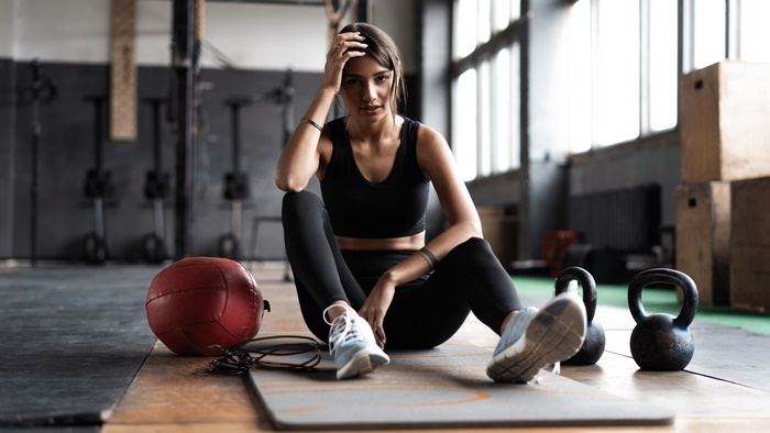 Woman in gym with workout equipment